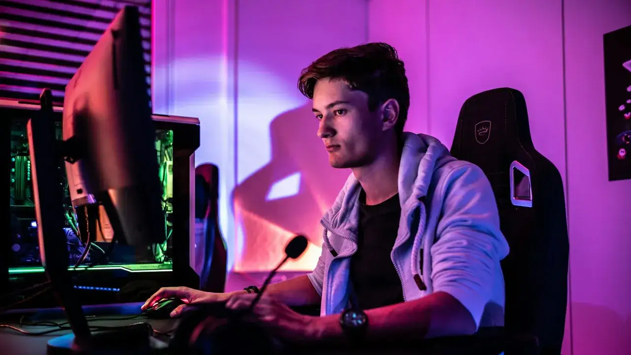 A streamer at a computer with a microphone